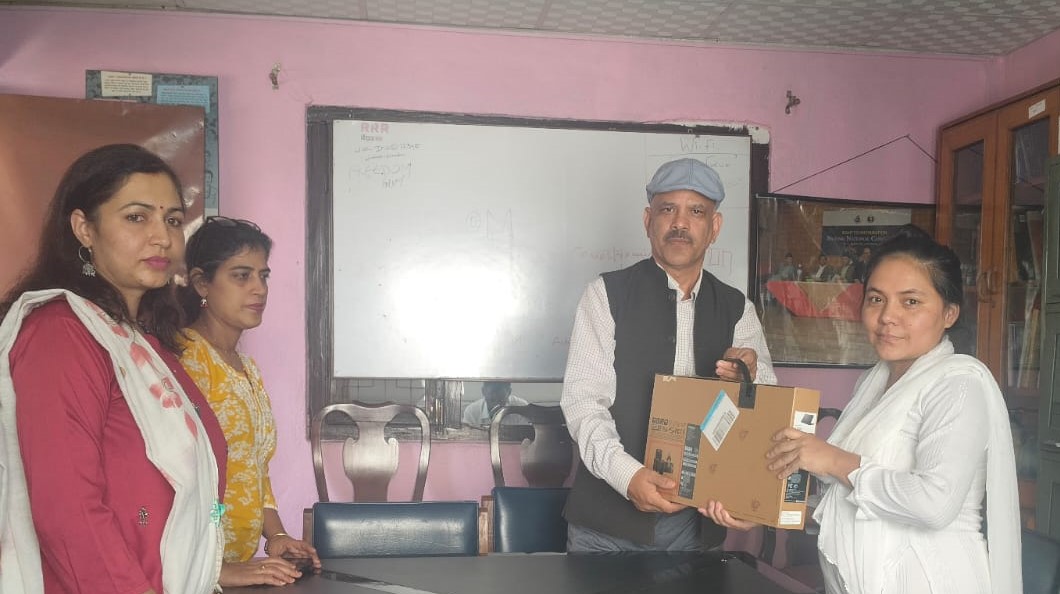 Journalist Maya Shrestha receiving laptop
